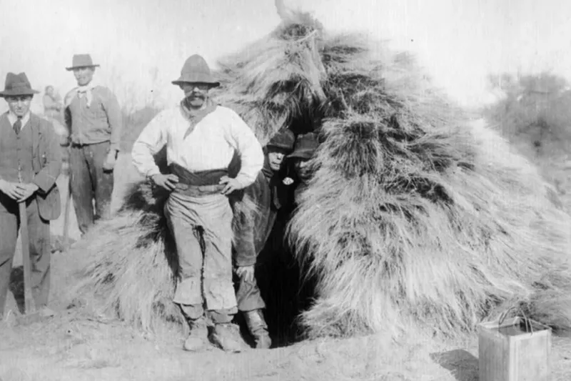 Detrás de uno de los hacheros se alcanza a visualizar las precarias viviendas donde pasaban el escaso tiempo libre (Foto: Archivo histórico provincial)