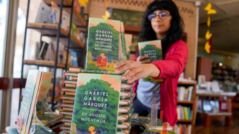 Una trabajadora en la librería del Centro Cultural Gabriel García Márquez acomoda ejemplares de ”En agosto nos vemos” la novela póstuma del autor colombiano y Premio Nobel de Literatura en Bogotá, Colombia, el miércoles 6 de marzo de 2024. (Foto AP/Fernan