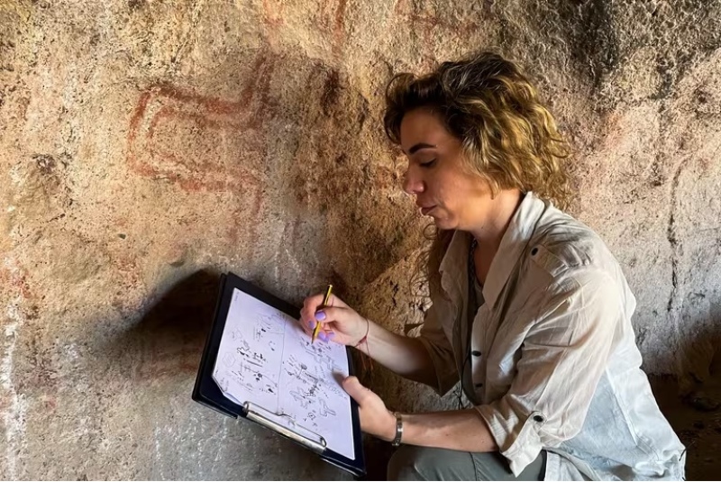  La arqueóloga Guadalupe Romero Villanueva toma notas junto al arte rupestre datado más antiguo de Sudamérica, en la cueva Huenul 1 en Neuquén (REUTERS/Miguel Lo Bianco)